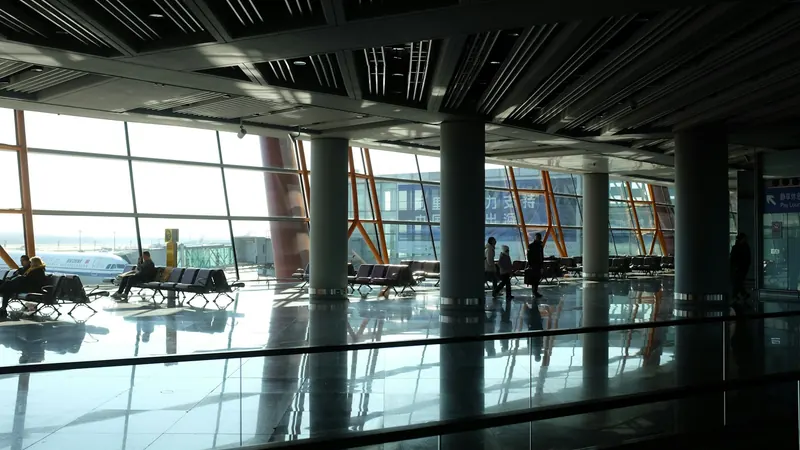 Seating and large windows inside a modern airport terminal
